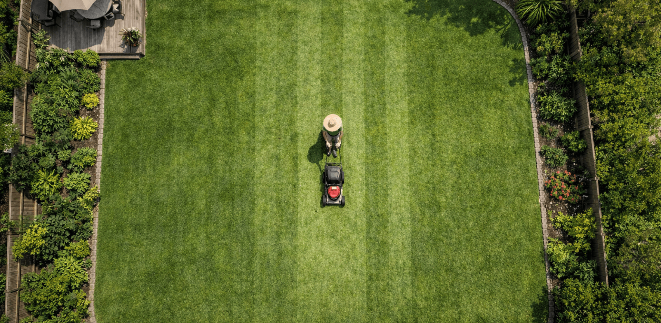 Lawn care professional mowing a beautiful lawn