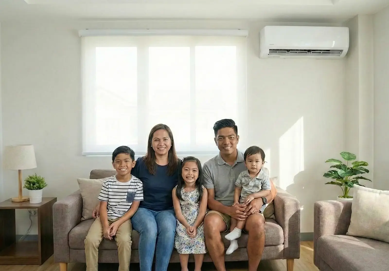 Happy family standing in their newly renovated kitchen, smiling as satisfied clients.